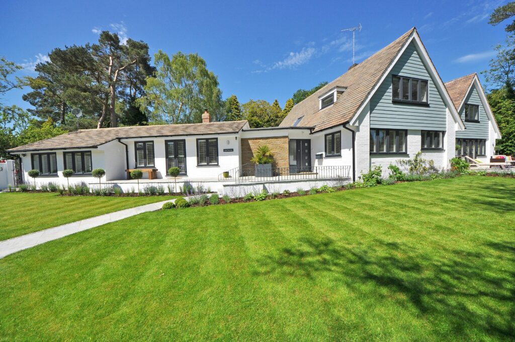 pexels-photo-280229-280229 Contemporary house exterior with large manicured lawn and beautiful garden.